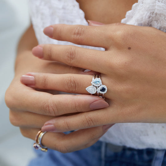 Pear shape cluster rings featuring aquamarine, sapphire and diamond.